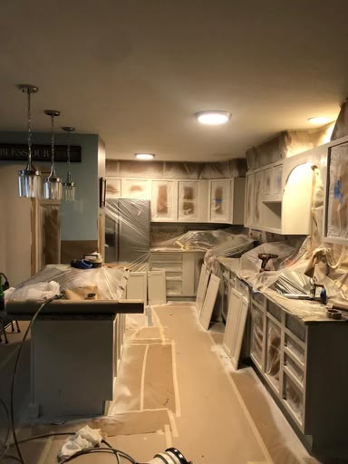 Kitchen fully masked and prepped for cabinet refinishing