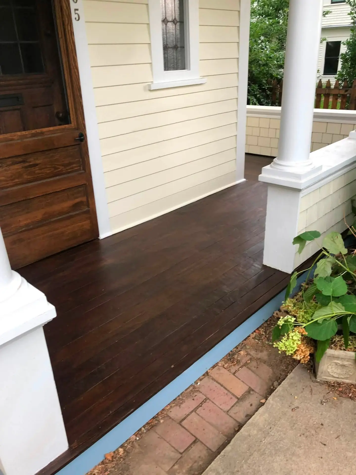 Front porch with refinished stained decking and freshly painted siding