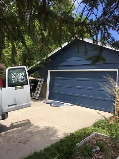 Home exterior and garage door repainted a deep blue