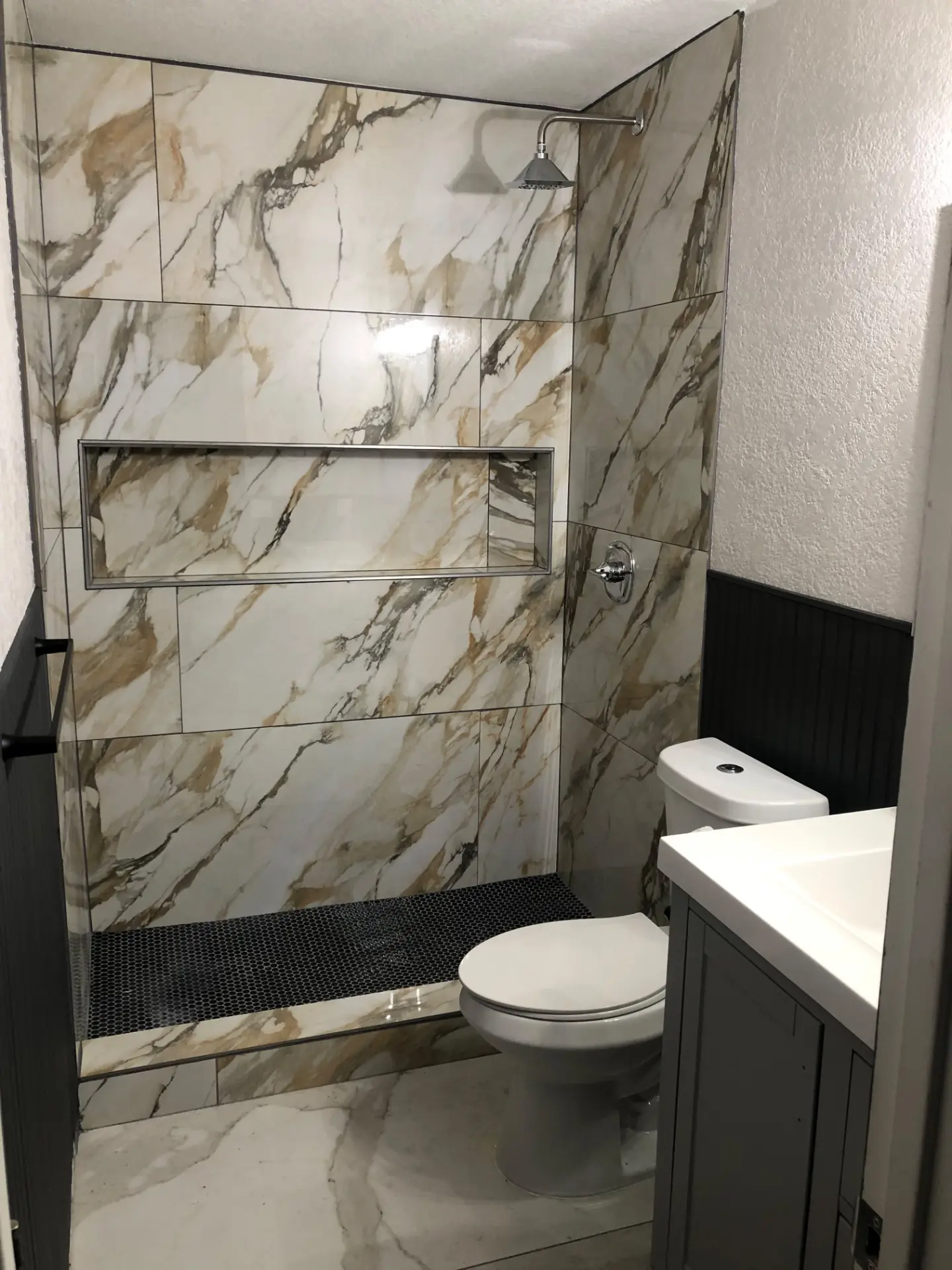 Marble tile walk-in shower in a freshly finished bathroom
