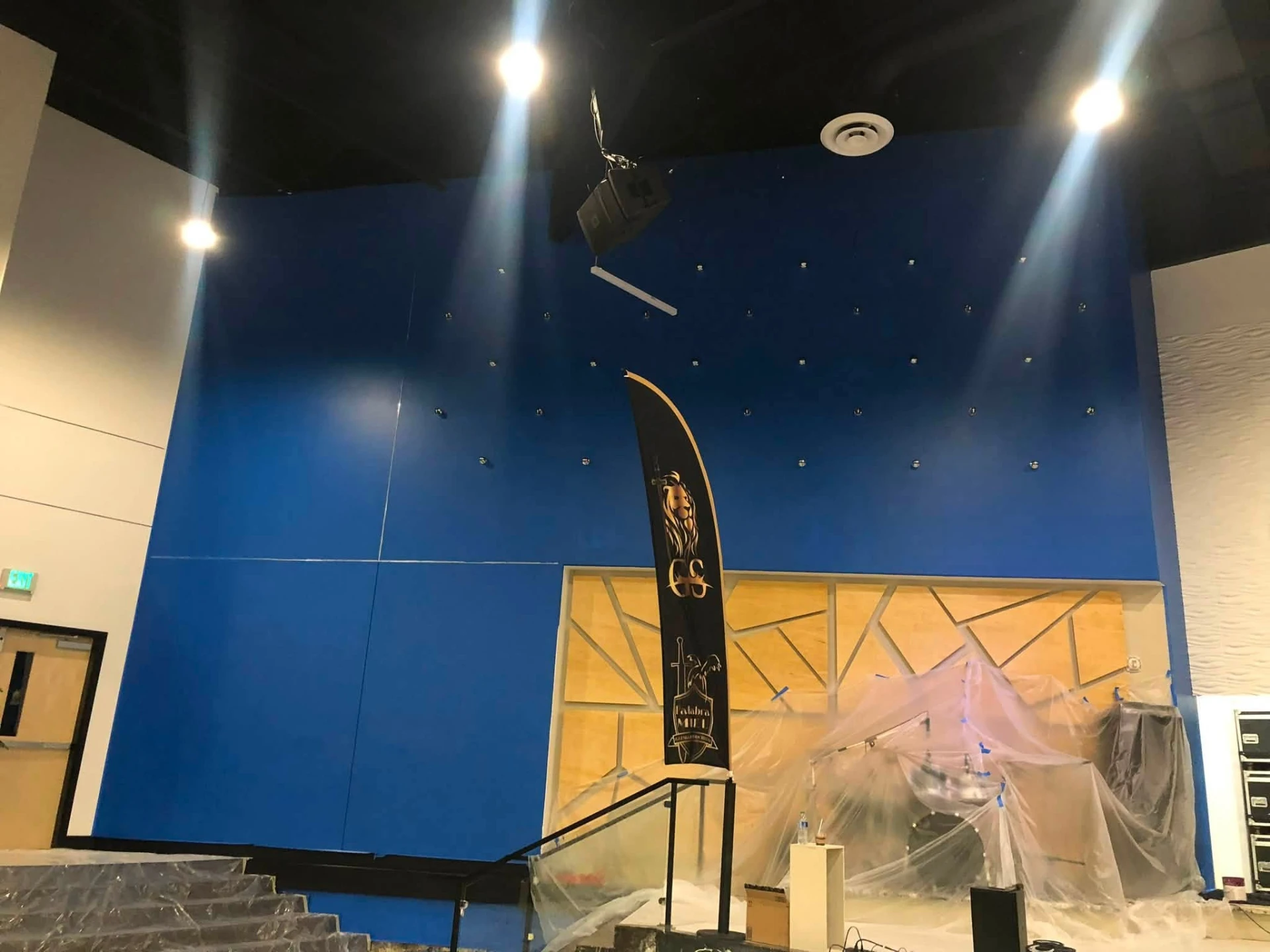 Tall church auditorium wall finished in deep blue paint